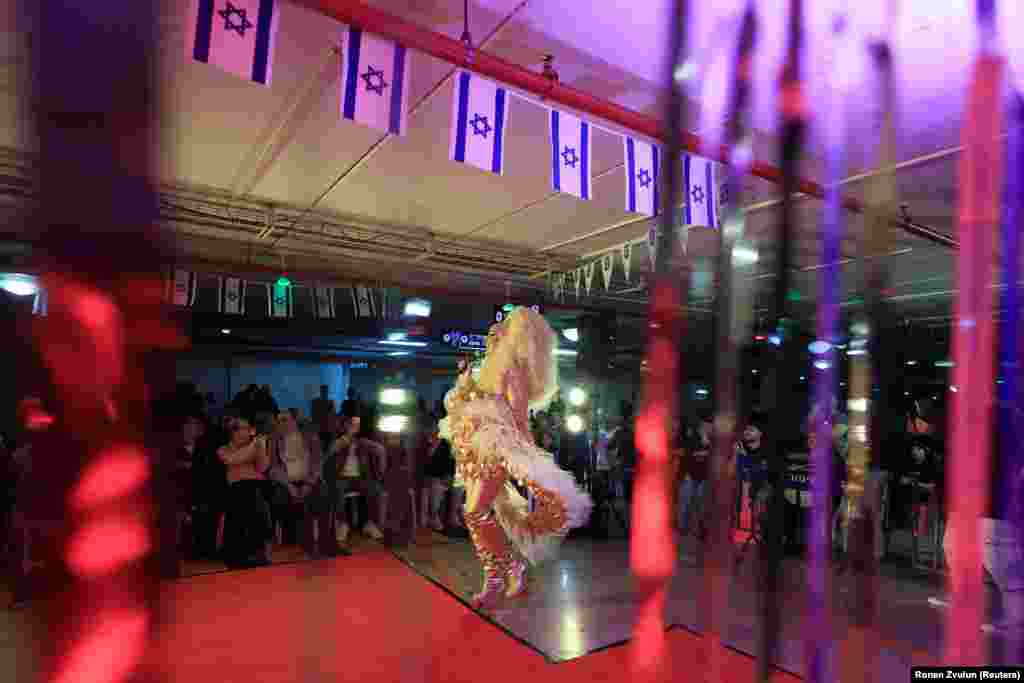 A drag queen performs inside an underground car park in Tel Aviv being used as a bomb shelter on March 31.