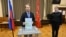 Russia's liberal Yabloko party leader Nikolai Rybakov casts his ballot with a marker writing "For peace" during Russia's parliamentary election at a polling station in Saint Petersburg on September 20.