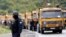 KOSOVO -- A Kosovo special police officer stands near trucks where Kosovo Serbs block a road near the northern Kosovo border crossing of Jarinje, September 20, 2021