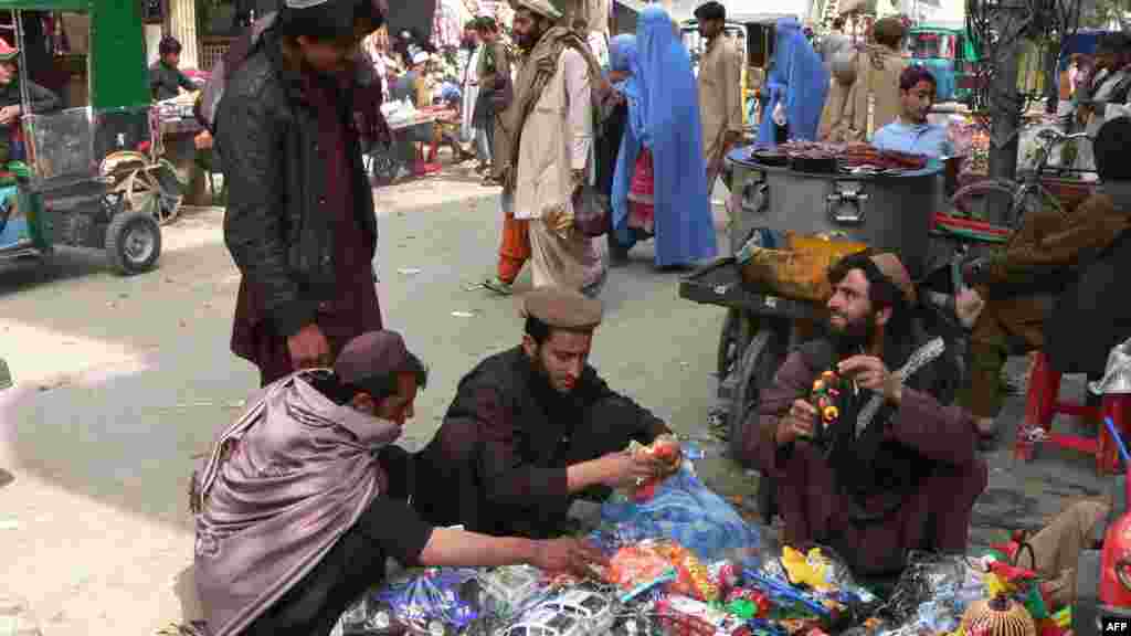 Afghanistan -- Men and women prepare to celebrate the traditional new year by purchasing gifts in Jalalabad, 19Mar2012