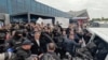 Уладзіміра Плахатнюка суправаджаюць да мікрааўтобуса, каб адвезьці з аэрапорту ў калёнію. Кішынёў, 25 верасьня 2025