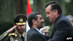 Iran -- President Mahmud Ahmadinejad greets his Tajik counterpart Emomali Rahmon (R) upon his arrival in Tehran, 26Mar2010