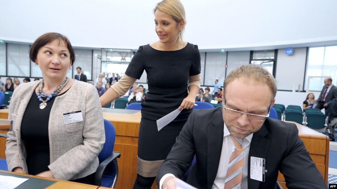 Yulia Tymoshenko's daughter Yevhenia Tymoshenko talks with her mother's lawyers Serhiy Vlasenko (right) and Valentyna Telychenko at the European Court of Human Rights in Strasbourg on August 28. 
