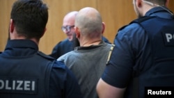Defendant Dieter S. is escorted at court, in Munich, Germany, May 20, 2025