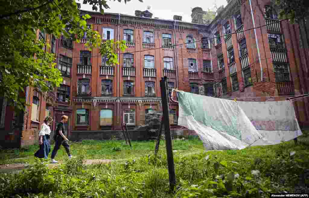 People walk past one of the dormitory buildings.&nbsp;Russian President Vladimir Putin has made the housing crisis one of the focal points of his much-trumpeted national projects. He has promised state financing to help boost new housing construction to 120 million square meters by 2024.&nbsp;People living in the Proletarka say none of this money has so far made its way to their home.