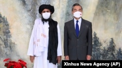 Taliban co-founder Mullah Abdul Ghani Baradar (left) and Chinese Foreign Minister Wang Yi at a meeting in Tianjin earlier this year. 