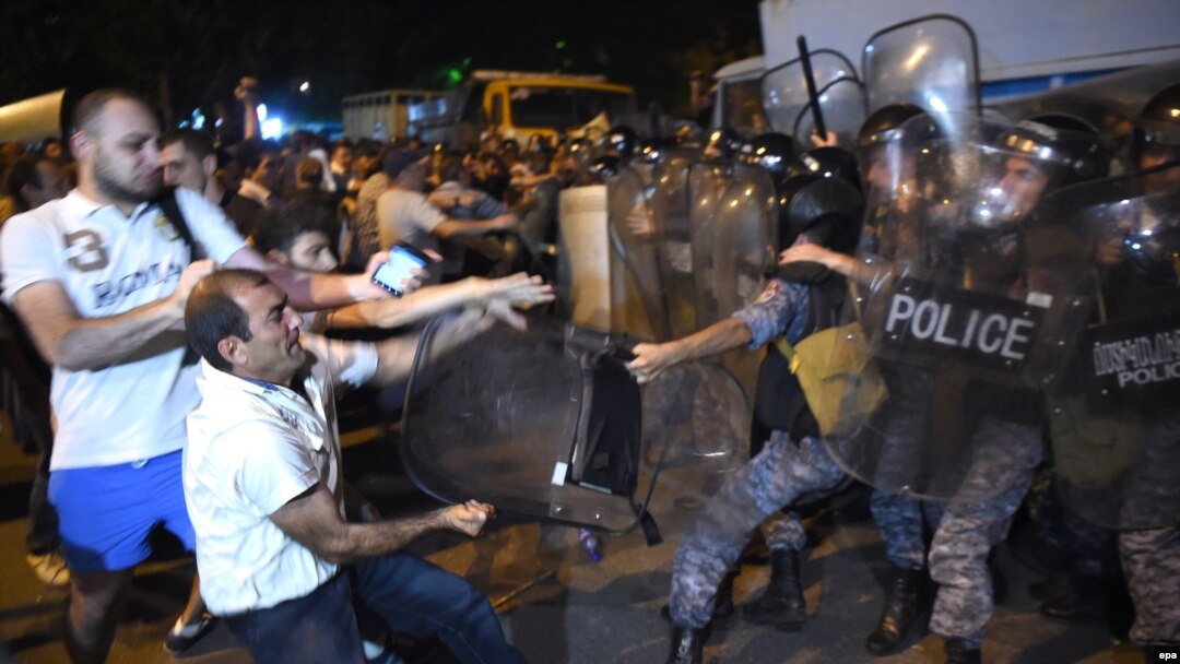 Protesters clash with police on July 20, 2016, near a police station that was seized by armed men a few days earlier.