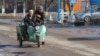 Люди едут на мотороллере. Село Сортобе, Жамбылская область. 2 февраля 2021 года.
