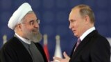 Friends and competitors -- Russian President Vladimir Putin (right) and his Iranian counterpart Hassan Rohani. 