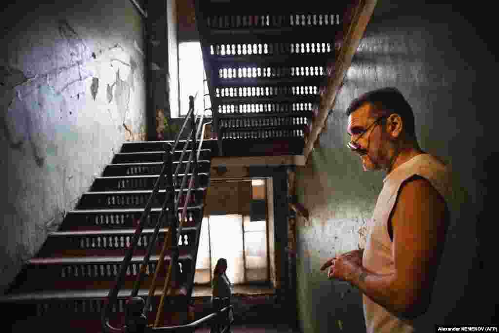 Vladimir Mogilnikov stands in a stairway of the dormitory.