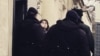 Khadija Ismayil tries to greet supporters and journalists outside the Baku courtroom on Januarya 27, when she had her pretrial detention extended. (POOR QUALITY PHOTO)