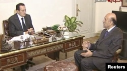 As vice president, Omar Suleiman (right) became a conspicuous face as the Arab Spring events culminated in the ouster of Egyptian President Hosni Mubarak. Here the two are meeting one day before Mubarak's resignation.