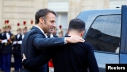 French President Emmanuel Macron (left) meets Ukrainian President Volodymyr Zelenskiy in Paris on October 10. 