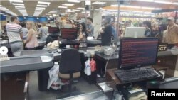 Customers queue at a supermarket in Kharkiv, Ukraine, during last year's Petya cyberattack.