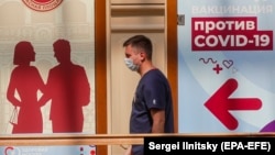 A man walks past a vaccination point at the State Department Store GUM in Moscow.