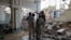 People gather at a damaged mosque following a suicide attack at a police facility in the Pakistani city of Kohat on September 18. 