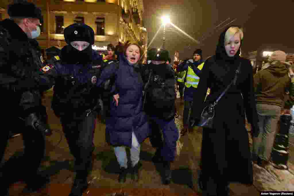 A woman is detained in St. Petersburg on February 2.