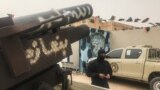 LIBYA - A local militiaman, belonging to a group opposed to Libyan strongman Khalifa Haftar stands next to vehicles the group said they seized from Haftar's forces in the coastal town of Zawiya, west of Tripoli, 5Apr2019