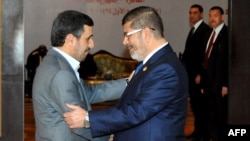 Egyptian President Muhammad Morsi (right) greets his Iranian counterpart, Mahmud Ahmadinejad, in Cairo