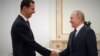 Russian President Vladimir Putin (right) meets with Syrian President Bashar al-Assad at the Kremlin in Moscow on September 13.