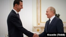 Russian President Vladimir Putin (right) meets with Syrian President Bashar al-Assad at the Kremlin in Moscow on September 13.