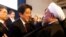 FILE PHOTO: Japan's Prime Minister Shinzo Abe greets Iran's President Hassan Rouhani (R) during the annual meeting of the World Economic Forum (WEF) in Davos January 22, 2014. REUTERS/Denis Balibouse/File Photo
