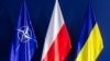 The flags of NATO, Poland, and Ukraine. Poland, the largest country on NATO's eastern flank, finds itself increasingly targeted by Moscow's intelligence services as Russia's invasion of Ukraine continues.