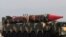 Pakistani military personnel stand beside a Shaheen III surface-to-surface ballistic missile during a military parade on March 23, 2017.