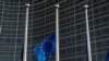 An European Union flag flies outside the EU Commission headquarters in Brussels.