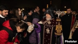 Armenia - Catholicos Garegin II blesses worshippers outside the Echmiadzin cathedral of the Armenian Apostolic Church, December 24, 2025.