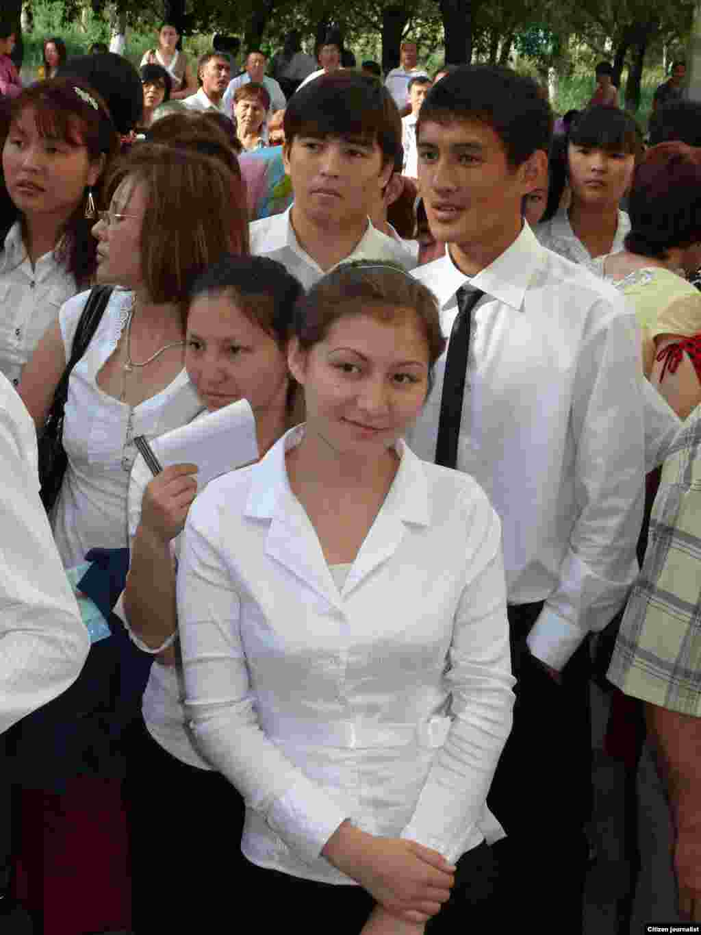 Students wait nervously before the start of a major high school exam. The results determine which university the students will attend.