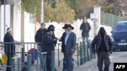 Evrei în fața școlii Ozar Hatorah de la Toulouse, unde trei copii și un adult au fost asasinați la 19 martie de un atacator necunoscut.