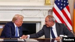 U.S. President Donald Trump shakes hands with Armenia's Prime Minister Nikol Pashinian during a signing event at the White House, Washington, August 8, 2025.