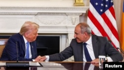 U.S. President Donald Trump shakes hands with Armenia's Prime Minister Nikol Pashinian during a trilateral signing event at the White House, Washington, August 8, 2025.