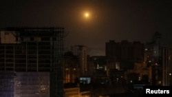 An explosion of a drone is seen in the sky over Kyiv during a Russian drone strike in the early hours of May 25.