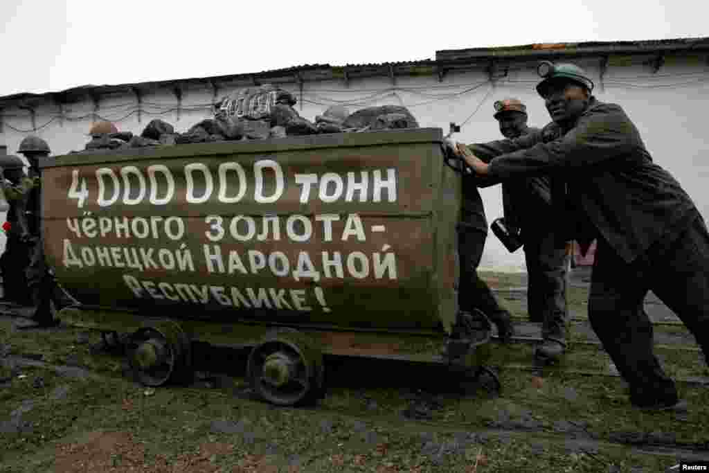 Miners take part in a ceremony marking the extraction of 4 million tons of coal by the MakeevUgol company, which owns the Kholodnaya Balka coal mine in Makiyivka, a town controlled by Russia-backed militants in the eastern Donetsk region of Ukraine. (Reuters/Aleksandr Yermochenko)