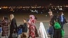 KOSOVO - Families evacuated from Kabul, Afghanistan, walk at Kosovo's capital Pristina International Airport , on Sunday, Aug. 29, 2021 Kosovo