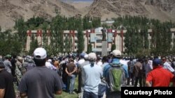 People in Khorugh protest against the killing of Imomnazar Imomnazarov outside the main administrative building on August 22.