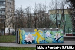 A shelter with flowers painted on it stands amid residential buildings in Dnipro on December 12