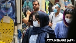 Iranians, some wearing protective gear amid the COVID-19 pandemic, shop at the Tajrish Bazaar market in the capital Tehran on July 14, 2020. 