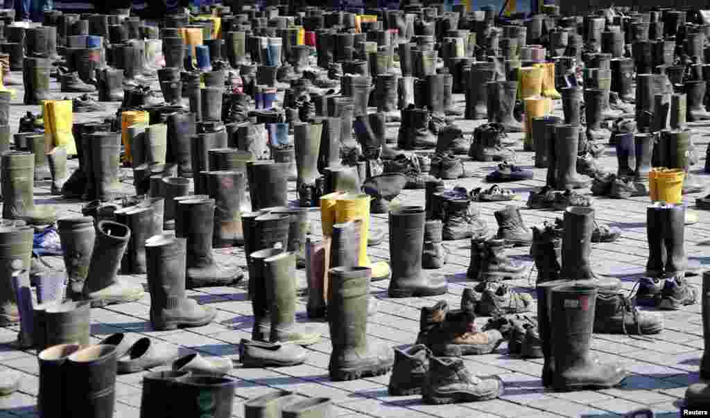 Pairs of used boots and shoes are displayed during a protest by German dairy farmers demanding a fair price structure for milk products in front of the Brandenburg Gate in Berlin on May 30. (Reuters/Fabrizio Bensch&nbsp;)