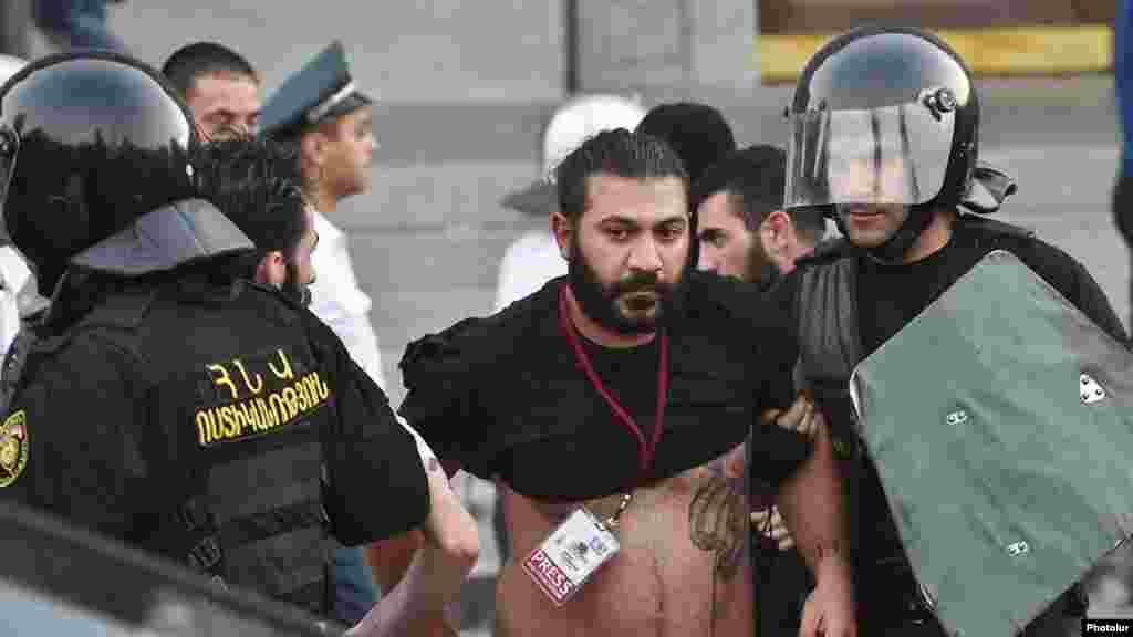 Karapet Sahakian, a photojournalist with Panorama.am, is detained by police in Yerevan.