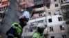 Firefighters work at a heavily damaged residential building following Russian drone and missile strikes in Kyiv on September 7. 