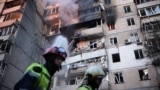 Firefighters work at a heavily damaged residential building following Russian drone and missile strikes in Kyiv on September 7.