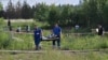 Russian law enforcement agents carry the body of former Transport Minister Roman Starovoit, who was found dead from a gunshot wound hours after his dismissal in Odintsovo, outside Moscow, on July 7.