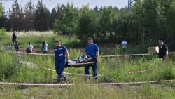 Russian law enforcement agents carry the body of former Transport Minister Roman Starovoit, who was found dead from a gunshot wound hours after his dismissal in Odintsovo, outside Moscow, on July 7.