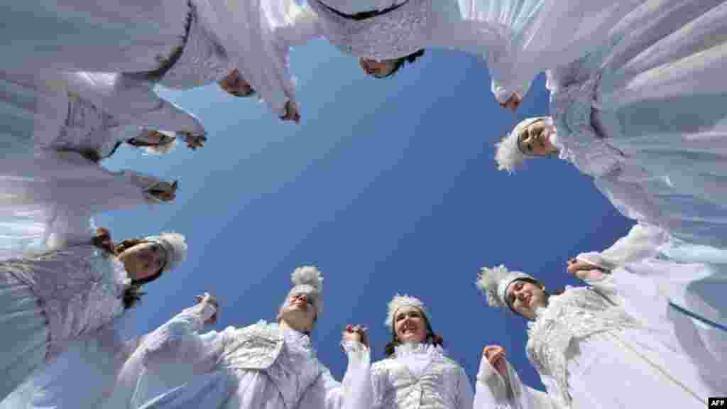 Kyrgyz girls wearing traditional costumes dance on Ala-Too Square in Bishkek as part of Norouz celebrations on March 21. (AFP/Vyacheslav Oseledo)