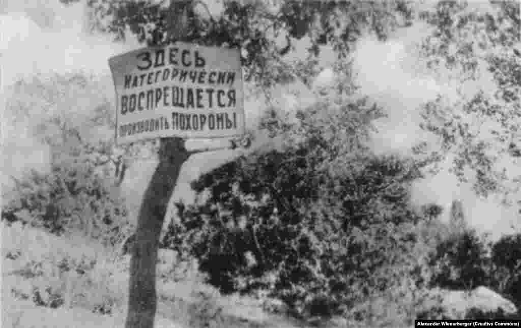 In the blooming countryside, a sign reads: &quot;The burial of corpses is strictly forbidden here!&quot;&nbsp;