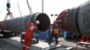 Рабочие на строительной площадке газопровода «Северный поток – 2» недалеко от города Кингисепп Ленинградской области. Россия, 5 июня 2019 года