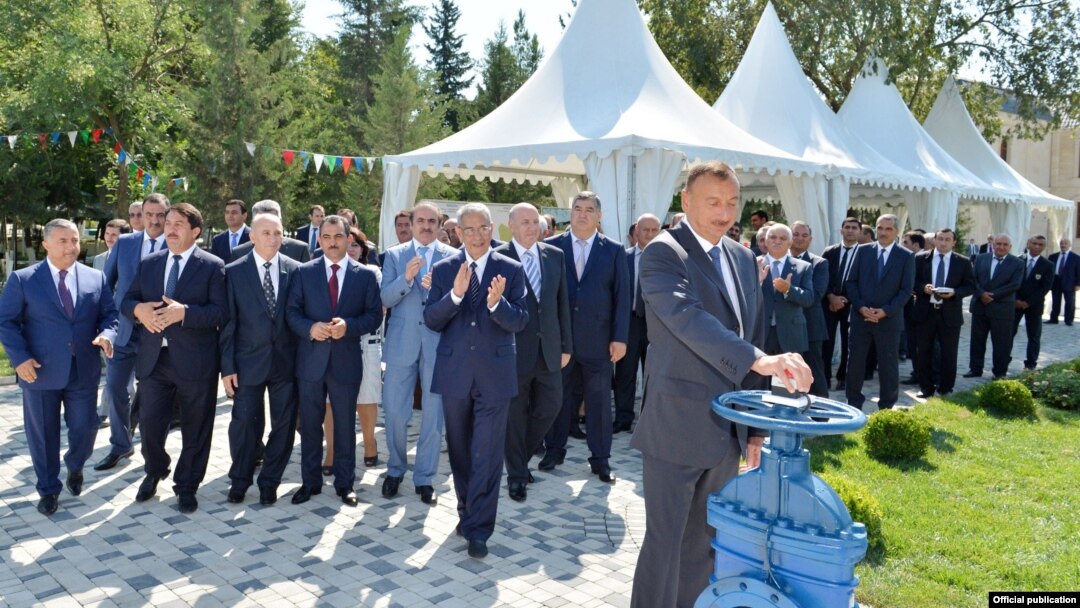 Azerbaijani President Ilham Aliyev (front), who took over from his father, attending a ceremony to mark new water supplies to the city of Kurdamir.